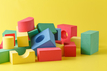 Naklejka premium building blocks on yellow background