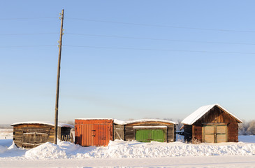 Four closed locks on the garage gate with colorful shot on a Sunny cold winter day