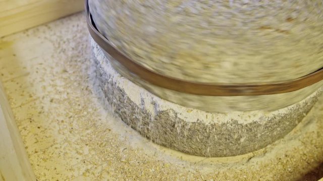 Historic hand-driven millstone grinding wheat