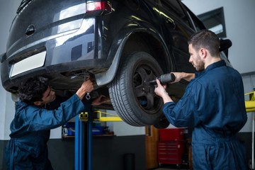 Mechanics fixing a car wheel