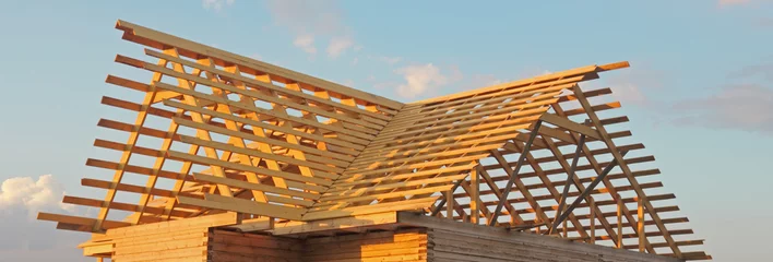 Foto auf Leinwand Timber house under constructoin - roof frame © sergeysikharulidze