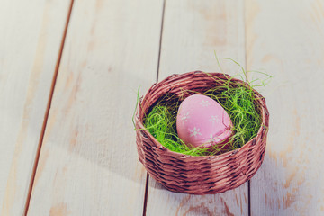 Easter eggs painted in pastel colors on white wooden background.