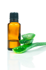 Sliced aloe leaves with a bottle of extract isolated on white background