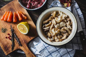 meat, mushrooms, tomatoes, vegetables and spices lie 