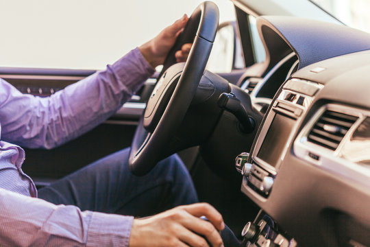 Close-up of a male hand  in a modern car