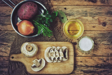 Fototapeta na wymiar fresh raw sliced mushrooms with herbs, potato and onion