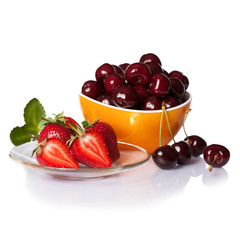 Strawberries and cherries in bowl close up isolated on white. Square.