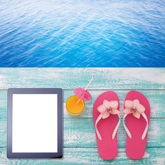 Blank empty tablet computer on beach. Trendy summer accessories on wooden background pool....