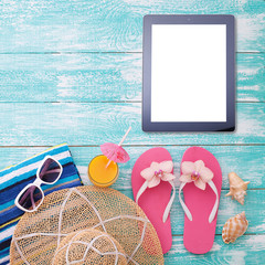 Blank empty tablet computer on beach. Trendy summer accessories on wooden background pool....
