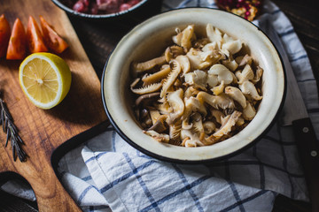 meat, mushrooms, tomatoes, vegetables and spices lie 
