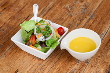 Fresh healthy salad on wooden table