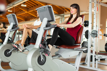 People working out on a stationary bike
