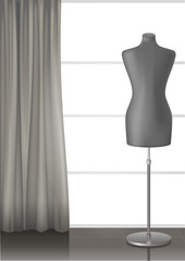 Mannequin for tailors in the interior of a modern studio with a large window and curtain