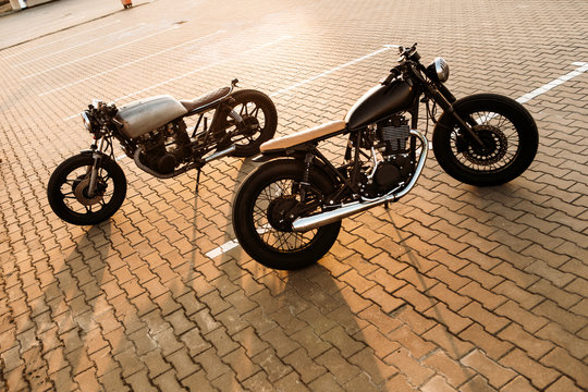 Two black and silver vintage custom motorcycles cafe racers