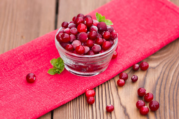 Red cranberries on wooden background