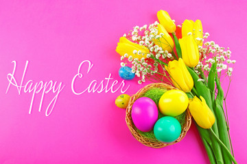 Easter greeting card. Multicoloured eggs and tulips on pink background