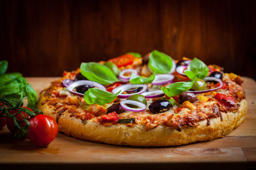 Traditional homemade pizza with tomatoes and olives