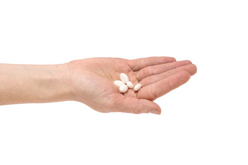 Hand with pills isolated on white