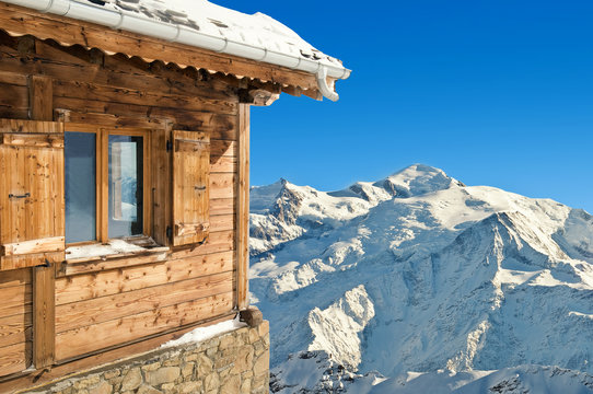 winter chalet in french alps mont blanc on blue sky background