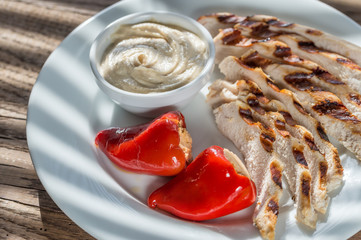 Grilled chicken with stuffed peppers and tahini sauce