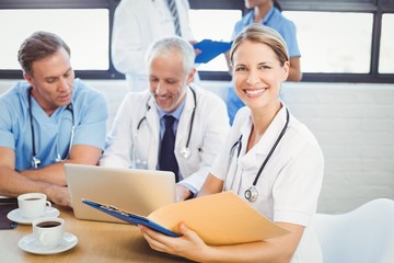 Female doctor holding a medical report