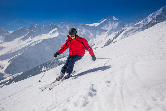 Young happy man skiing in Lenzerheide ski resort, Switzerland.