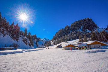 Fototapeta premium Skiers skiing on ski slopes on the top of Hoch Ybrig resort, Switzerland 