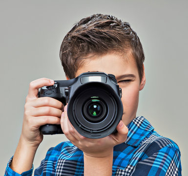 Boy with camera taking pictures.