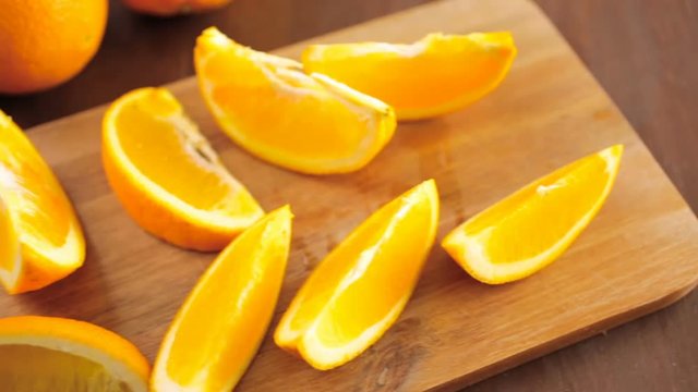 Slices of organic navel orange on cutting board