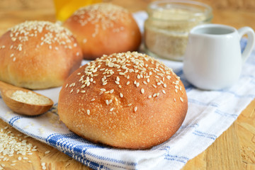 homemade buns with sesame seeds and milk for breakfast