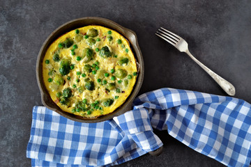Frittata with cheese, green peas and Brussels sprouts