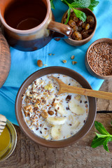Granola with milk, walnuts and a banana for breakfast