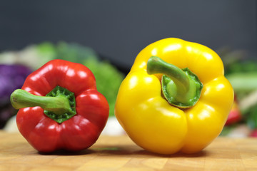Red and yellow pepper, on a chopping board
