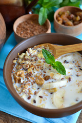 Granola with milk, walnuts and a banana for breakfast