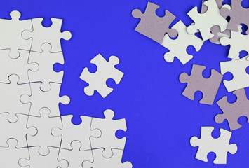 Fototapeta premium Puzzle pieces on blue background
