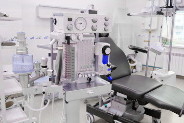 interior of the operating room in dental clinic with the anesthesiology machine on the frontground