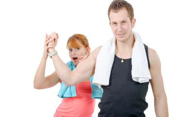  woman examining flexing biceps of her muscular boyfriend