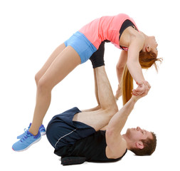 Beautiful young woman and man doing stretching exercises