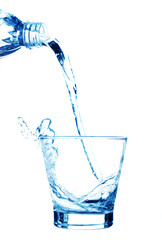 Pouring water on a glass on white background
