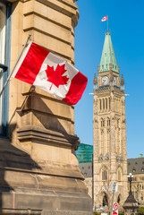 Close up of peace tower (parliament building) in Ottawa, Canada, with canadian flag.