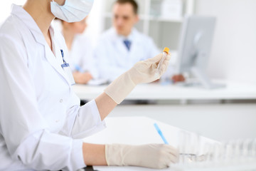 Scientific research team with clear solution in laboratory