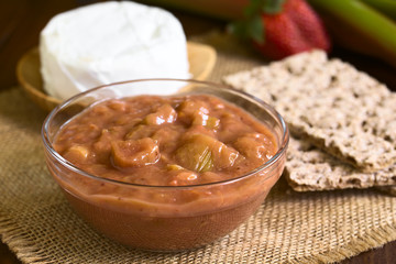 Homemade rhubarb and strawberry chutney in glass bowl, photographed with natural light (Selective Focus, Focus one third into the chutney)