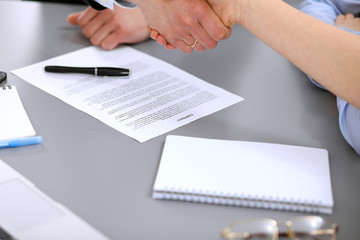 Business people shaking hands , finishing up a meeting to sign a new contract