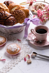 Coffee and french pastry, sweet desserts for breakfast with spring tulip flowers, vintage porcelain cup. Lovely breakfast.