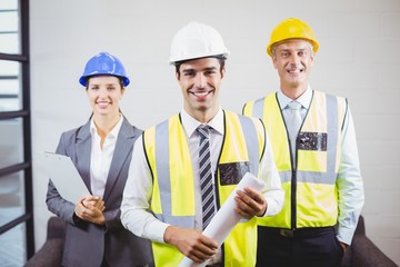 Portrait of smiling architects with blueprint 