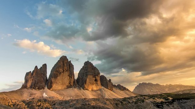 time lapse of dolomites peaks tre cime di lavaredo from day to night clouds moving over the mountains
