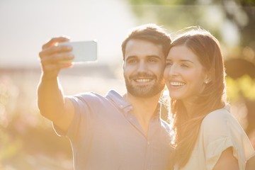 Happy couple clicking selfie with smart phone