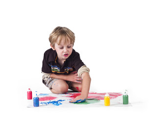 image of a elementary boy drawing on piece of paper.