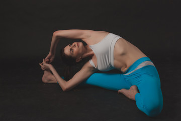 Beautiful sporty yogi girl practices yoga asana