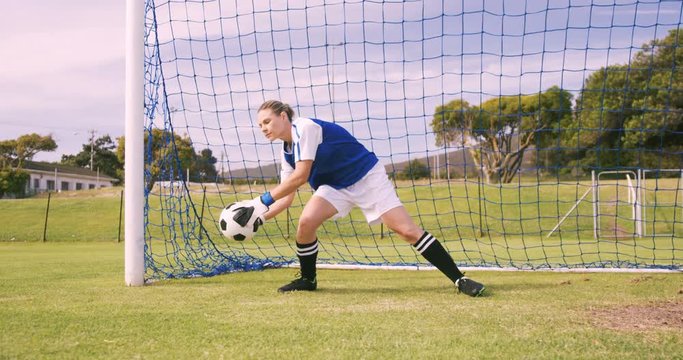 Goalkeeper in blue making a save